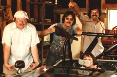 The gang "fixing" the car